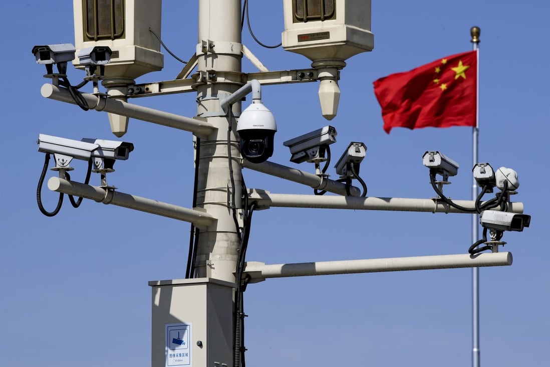 Surveillance cameras mounted on a lamp post in Tiananmen Square in Beijing. Photo: AP
