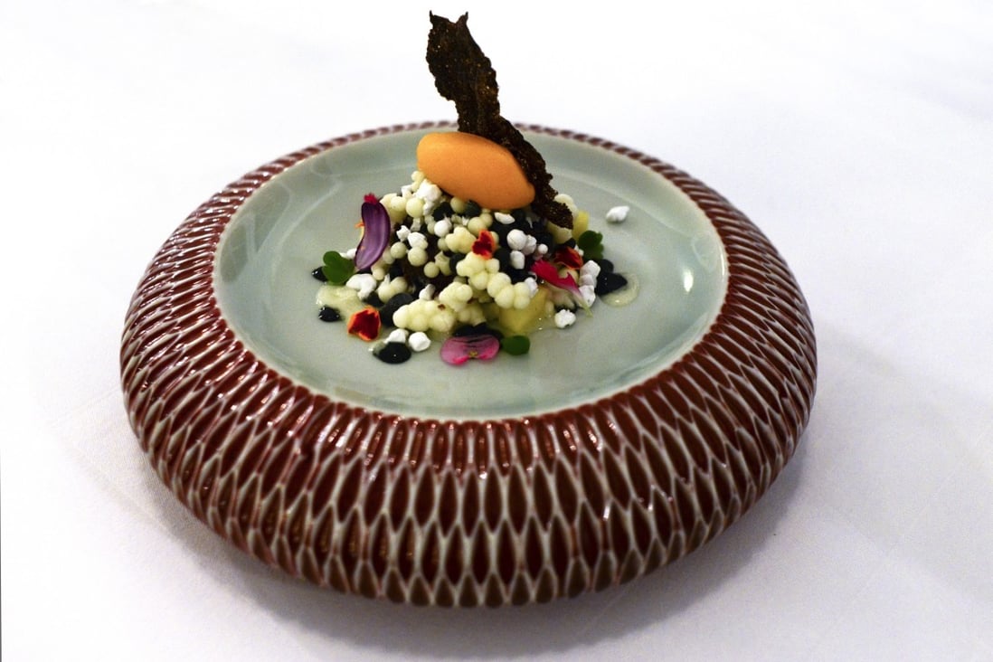 The dessert of mango sorbet, coconut pearls and black sesame purée, is one of the fine-dining offerings served at the restaurant Aperitif, at Viceroy Bali, in Ubud, Bali.