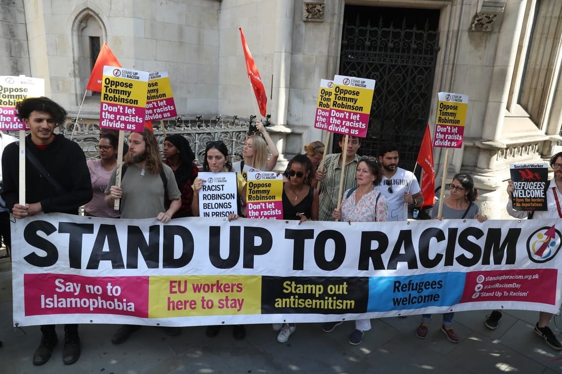 Activists hold banners from the Stand Up To Racism campaign in London. File photo: AFP