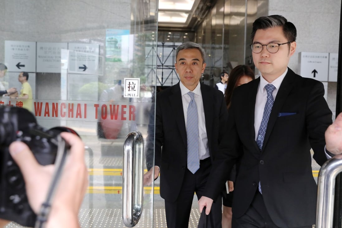Wilson Fung Wing-yip (left), the former deputy secretary for economic development and labour, arrives at the District Court in Wan Chai on Monday. Photo: K.Y. Cheng