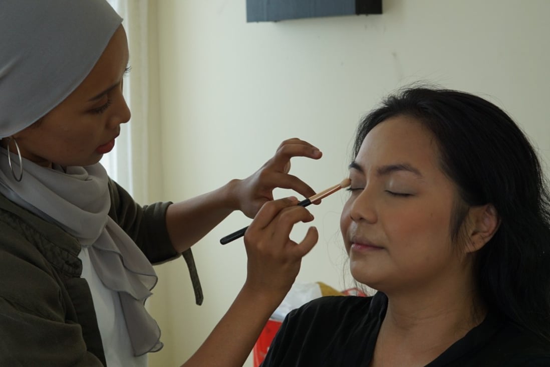 Malaysian make-up artist Jia works on one of her clients. Unlike most, Jia doesn’t use heavy contours or highlights, fill eyebrows with powder, pencil and concealer, or make her nose appear higher.