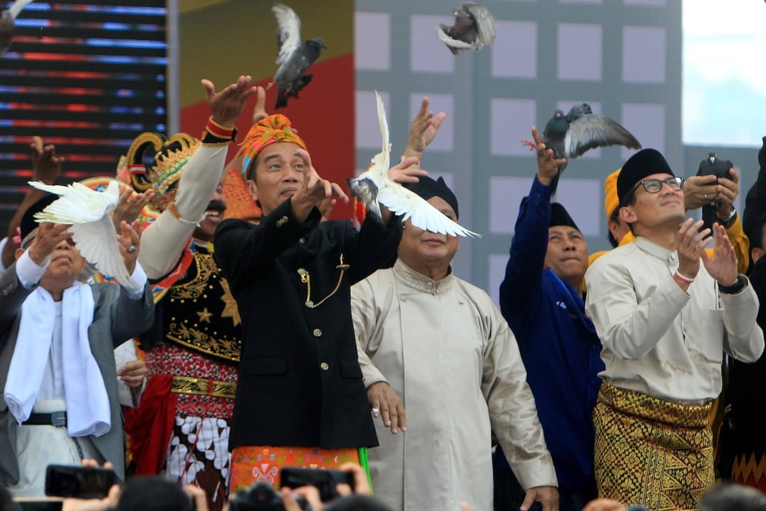 Indonesian President Joko Widodo and his running mate Ma’ruf Amin, left, together with their election opponents Prabowo Subianto and Sandiaga Uno, release birds before the election to symbolise a peaceful campaign. Photo: EPA
