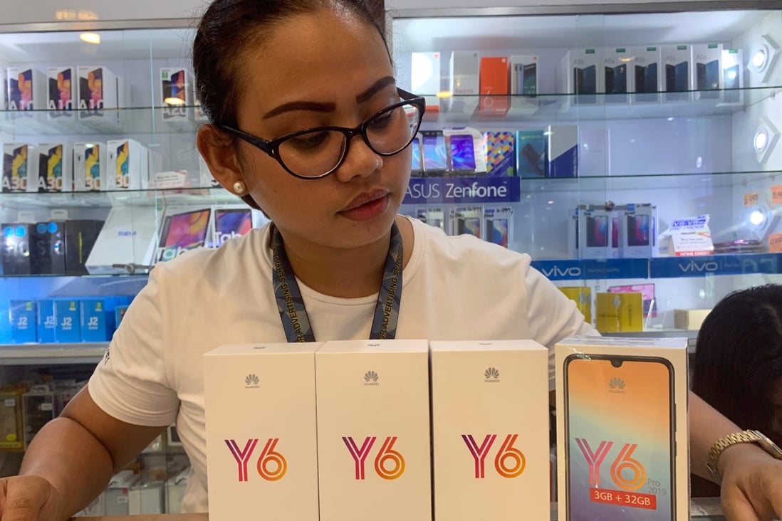 Rizal Anotado, the manager of a phone reselling shop in the southern Philippine city of Koronadal, displays her Huawei Y6 devices. Photo: Jef Maitem