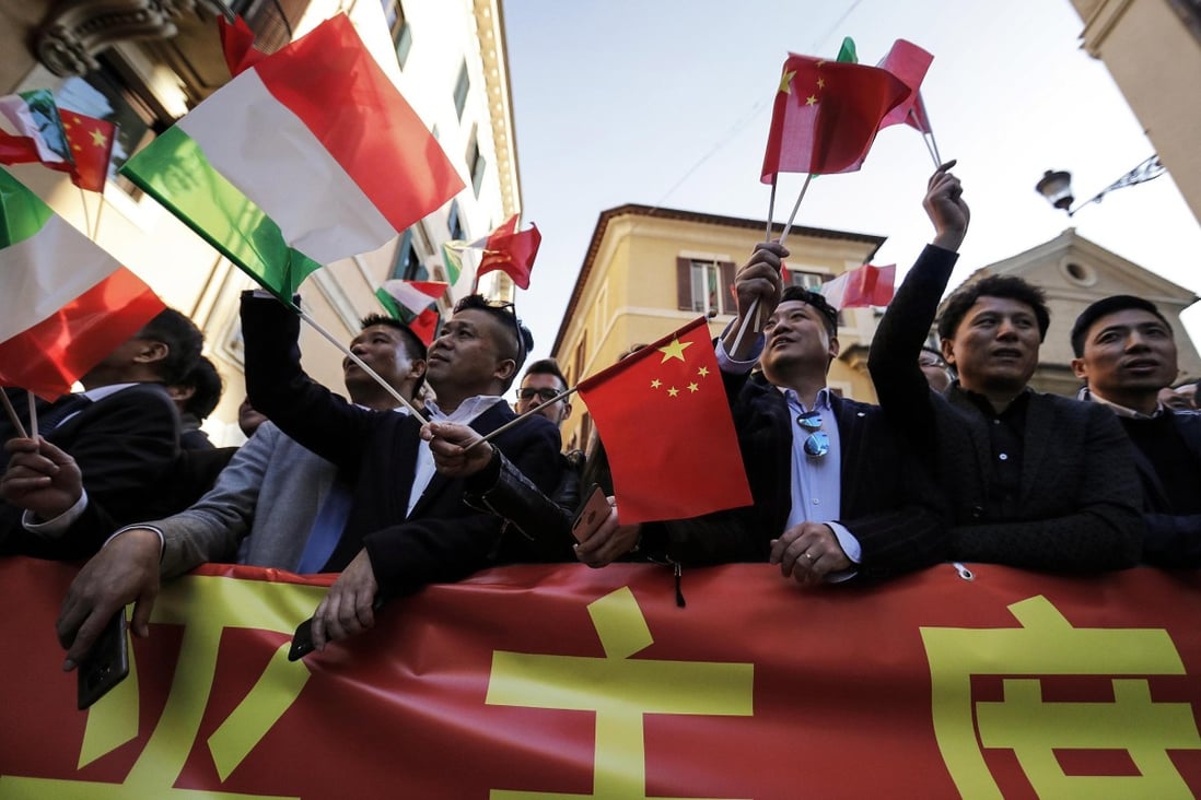 Chinese residents of Italy wave Chinese and Italian flags as they wait for the arrival of Xi Jinping in Rome on March 22. China has long viewed language instruction as a necessary component for achieving diplomacy and trade goals, and the Belt and Road Initiative has resulted in a wave of new languages as majors. Photo: EPA-EFE