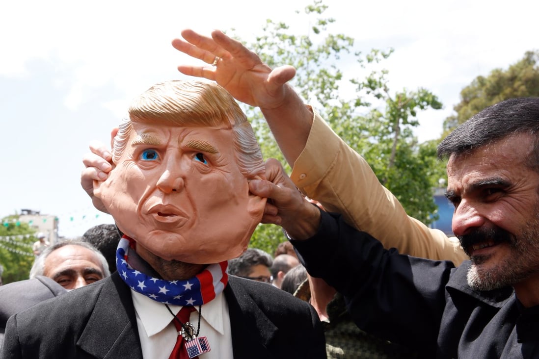 Demonstrators tug at a mask of President Donald Trump at an anti-US rally in Iran on May 10. Whether it is Iran, North Korea, Venezuela or China, Trump has failed to solve the knottiest US foreign policy dilemmas with the sheer force of his deal-making savvy or charisma. Photo: EPA-EFE