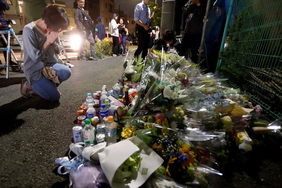 A local resident prays to mourn victims of Tuesday’s mass stabbing in Kawasaki, Japan. Photo: Reuters