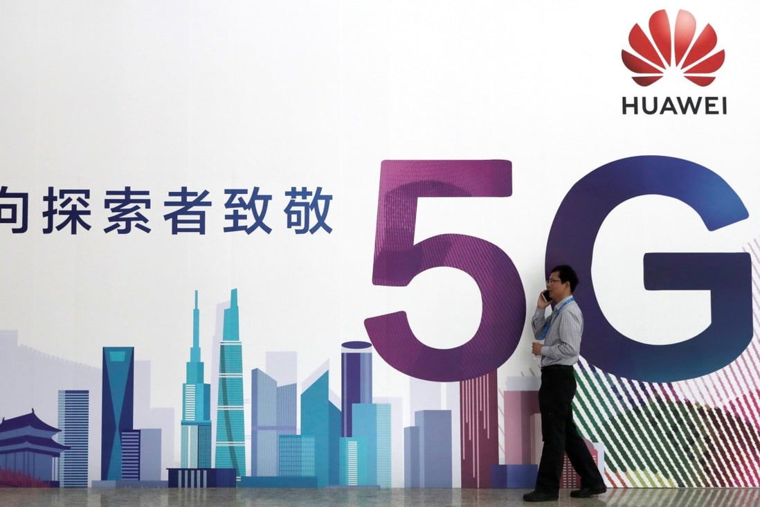 A man talks on his smartphone beside Huawei's billboard featuring 5G technology at the PT Expo in Beijing, China, September 26, 2018. Photo: Reuters