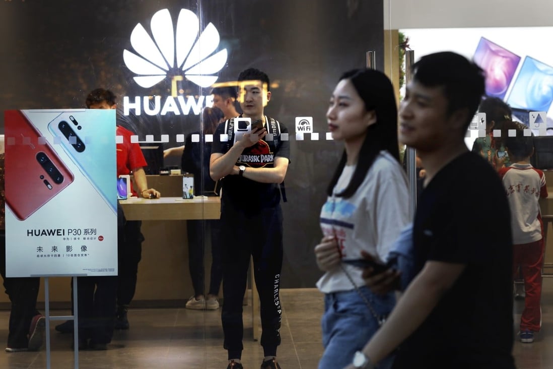 Shoppers visit a Huawei Technologies retail store in Beijing. Photo: AP