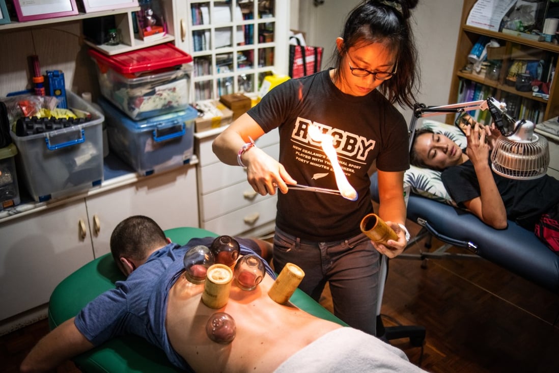 Toto Cheng, a practitioner of traditional Chinese medicine, performs cupping therapy on a client in her clinic in North Point, Hong Kong. A sportswoman herself, her clients are involved in various sports. Photo: Laurel Chor