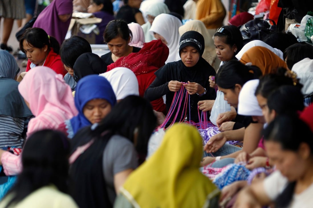 Indonesian domestic workers in Hong Kong's Victoria Park. Officials from the country have mooted a policy that would stop women working overseas as maids. Photo: AFP