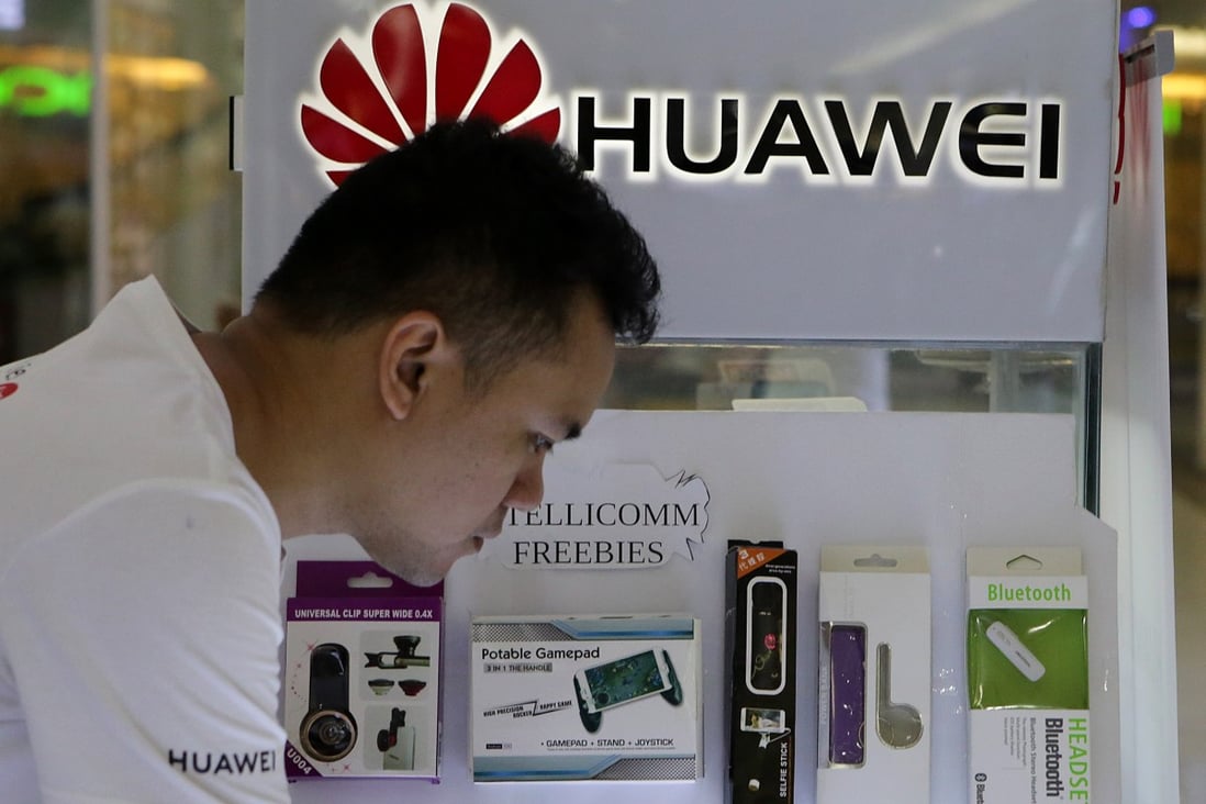 A salesman works at a Huawei booth in Manila. Photo: Xinhua