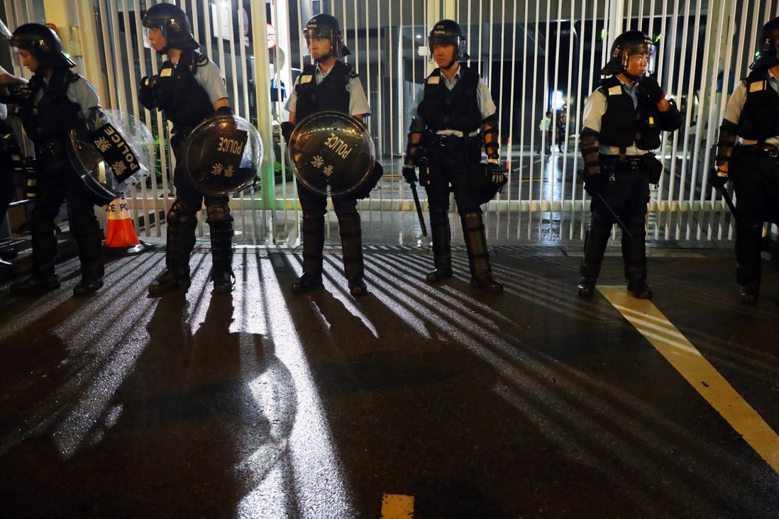 Police officers surround the legislature in the early hours of Wednesday. Photo: Edmond So