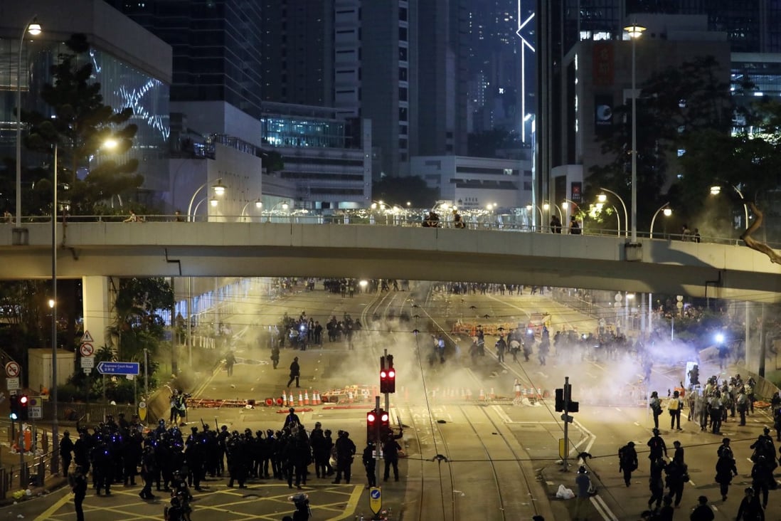Police push through barricades against protesters on Wednesday. Photo: Sam Tsang