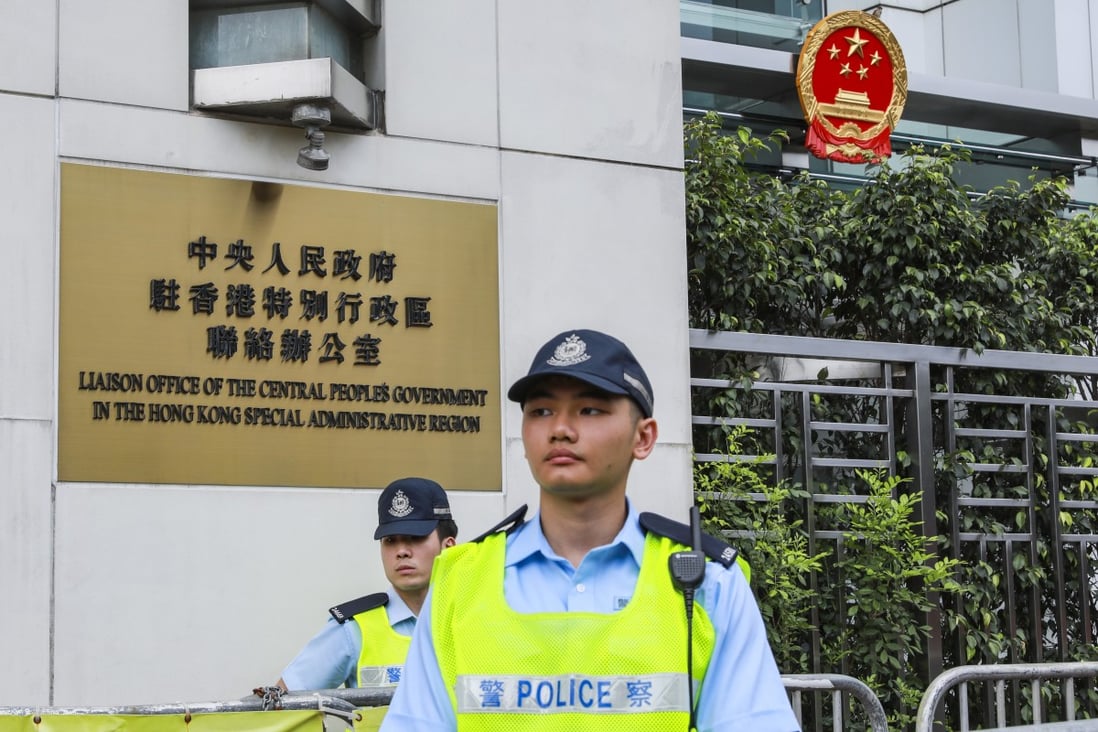 Two police officers stand guard outside The Liaison Office of the Central People's Government in the HKSAR in Sai Wan. Photo: May Tse