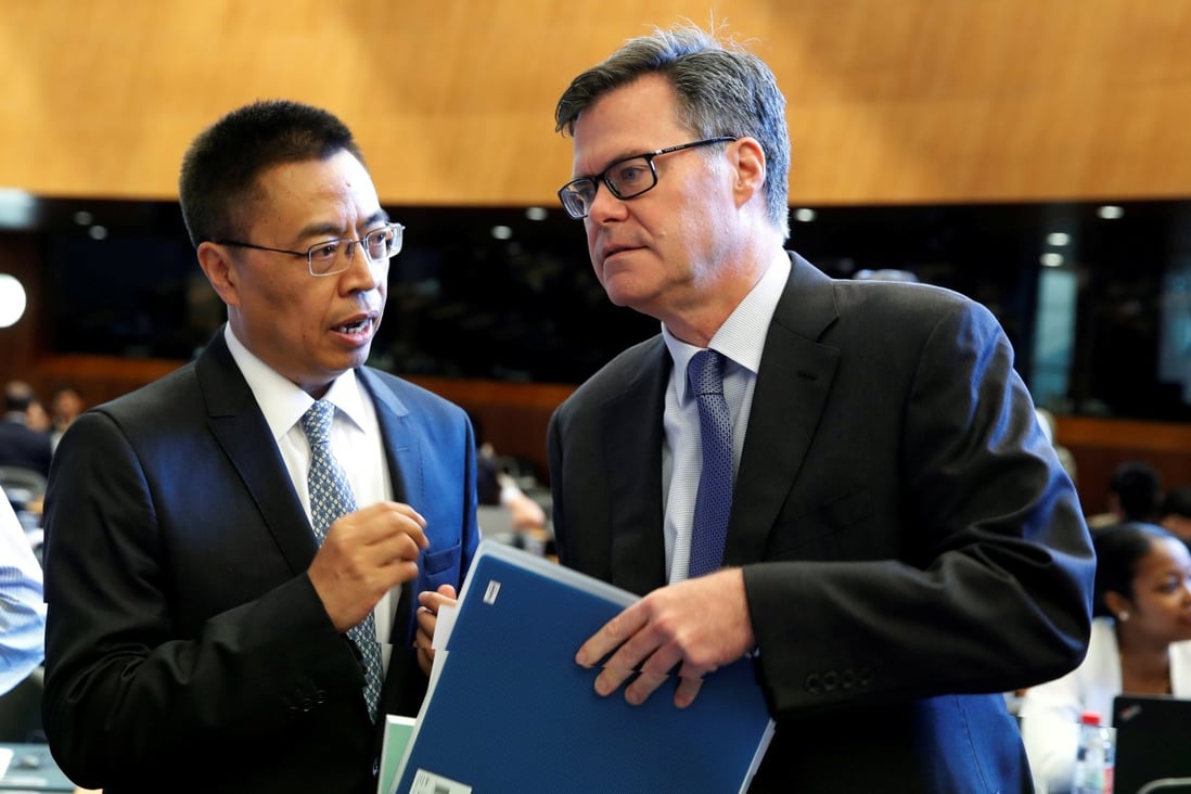 Dennis Shea, US Ambassador to the WTO talks with Xiangchen Zhang, Chinese Ambassador to the WTO before the General Council meeting at the World Trade Organisation in Geneva, Switzerland, July 26, 2018. Photo: Reuters