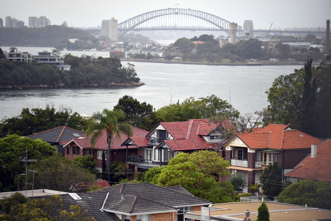 Property analysts point to the results of a land auction on June 8 where 62 per cent of properties were sold as an indicator that the property market was turning around. Single detached houses in inner Sydney, Australia are framed by the Sydney Harbour Bridge. Photo: EPA