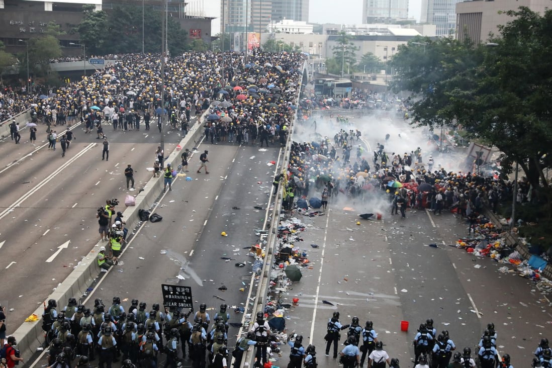 Riot police fire tear gas and push anti-extradition bill protesters away from the Legislative Council Complex along Harcourt Road last Wednesday. Photo: K.Y. Cheng