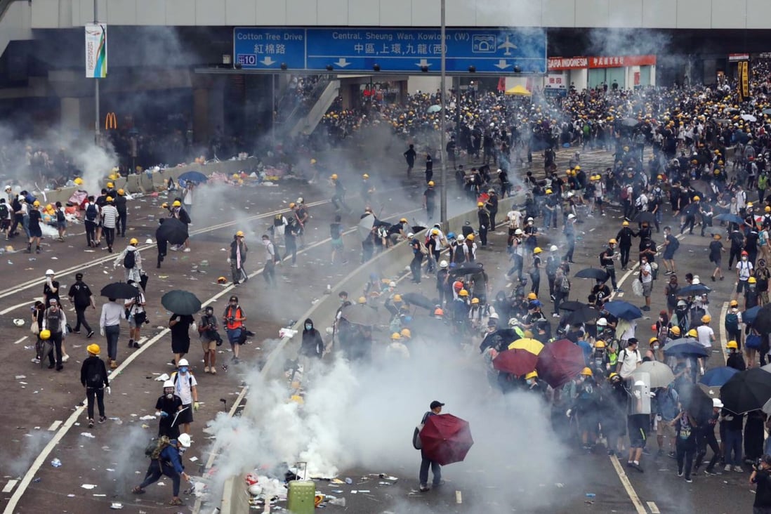 Protesters on the receiving end of tear gas on the junction of Harcourt Road and Gloucester Road during clashes on June 12 that left dozens injured, including one person who was refused treatment at a private hospital. Photo: Sam Tsang