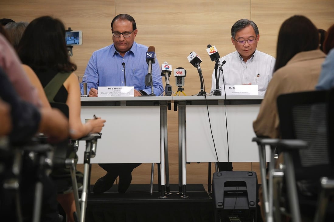 Singapore's Minister for Communication and Information S Iswaran, left, and Minister of Health Gan Kim Yong conduct a press conference. Photo: EPA-EFE