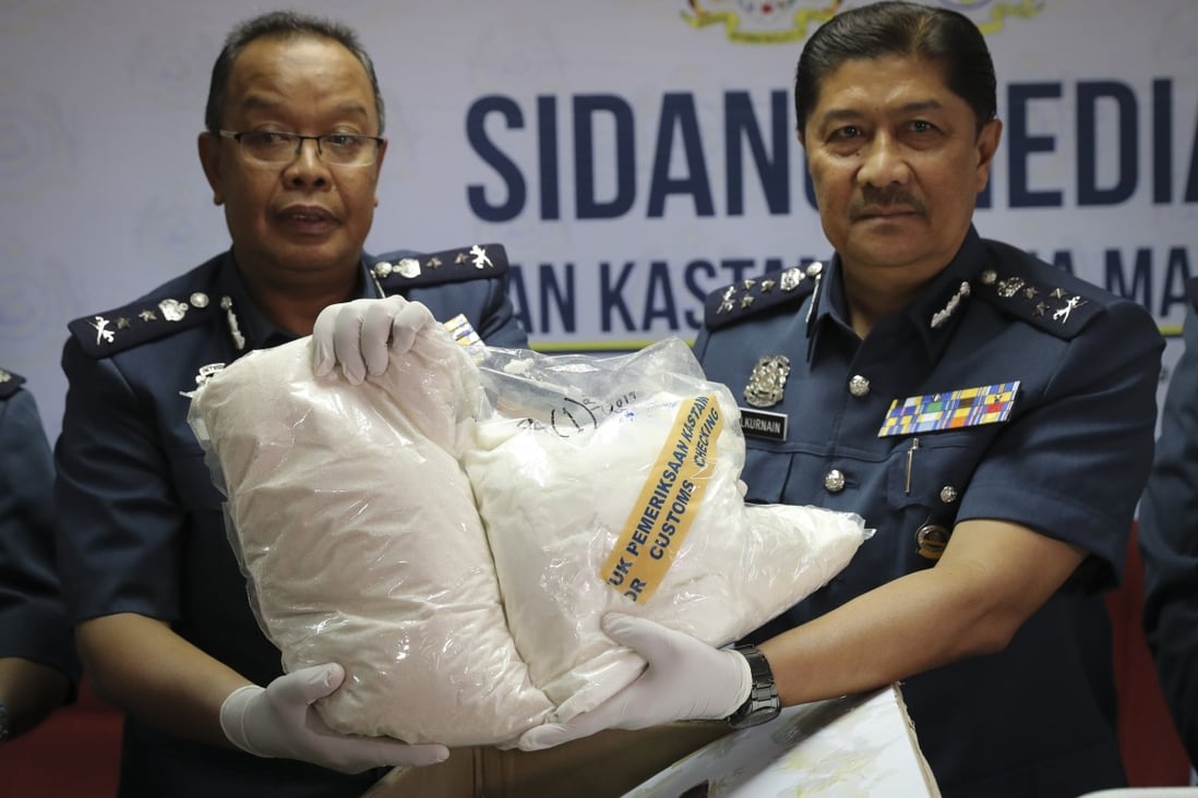 Customs officials display seized drugs in Sepang. Malaysia's government has announced plans to remove criminal penalties for the possession and use of drugs in small quantities. Photo: AP