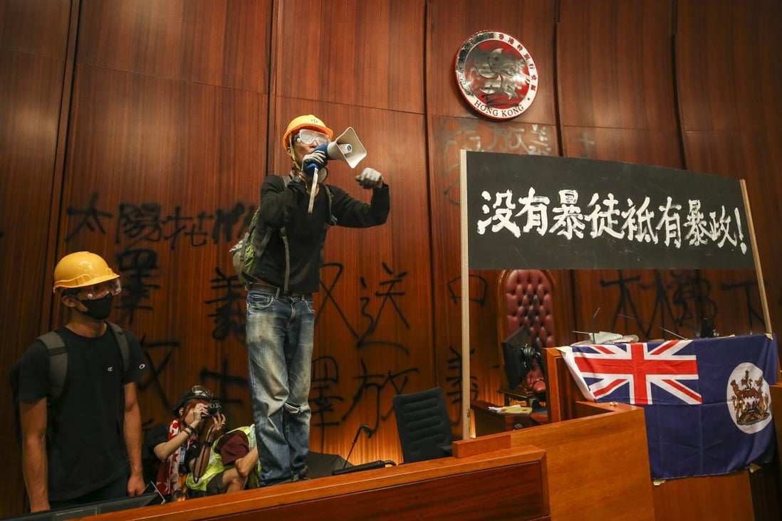 Protesters display a banner reading: ‘There are no rioters, but a tyrannous government’ after occupying the Legislative Council chamber. Photo: Winson Wong