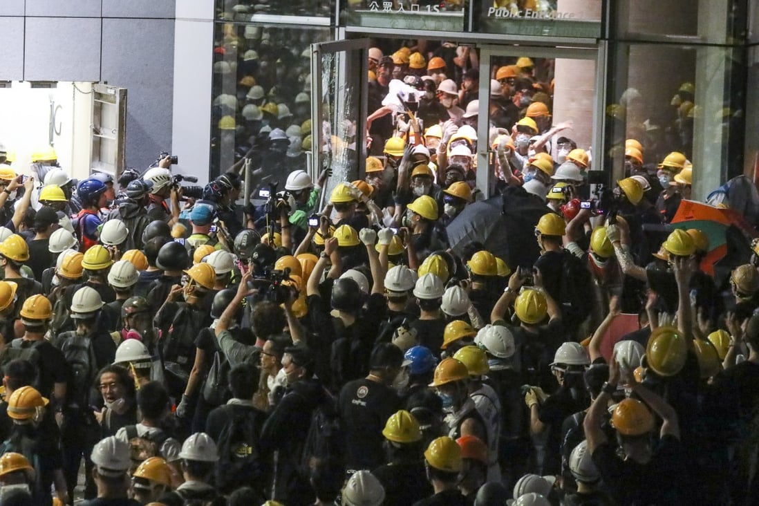 Protesters enter the Legislative Council building during a protest against the extradition bill on Monday. Photo: Dickson Lee