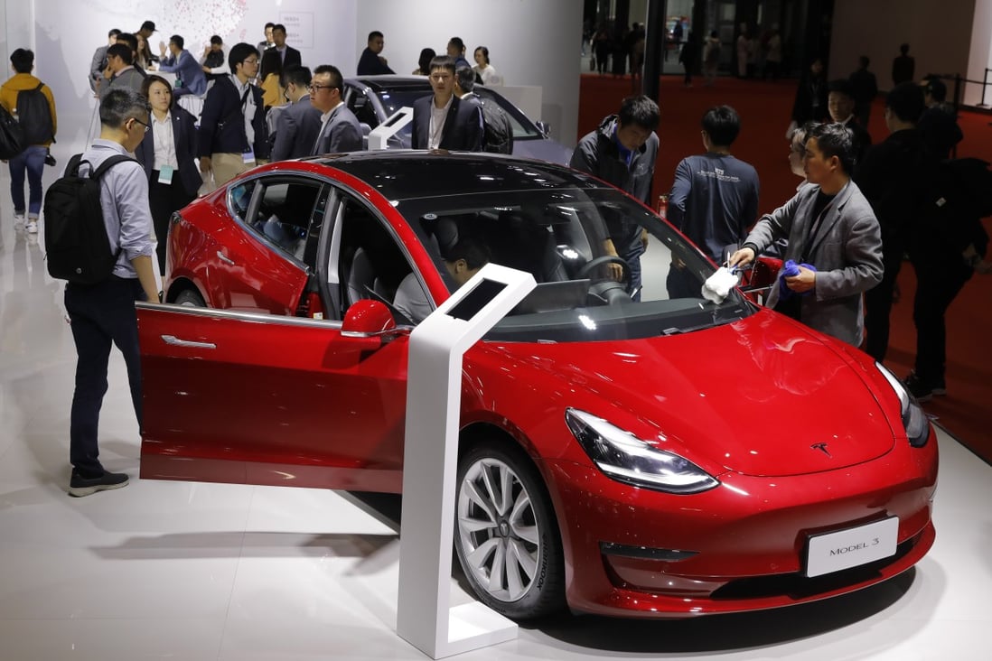 Visitors inspect a Tesla Model 3 during the media day of the Auto Shanghai 2019 motor show in Shanghai on April 16. Photo: EPA-EFE
