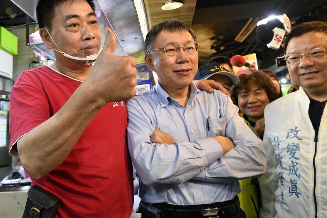 Taipei mayor Ko Wen-je poses for pictures with supporters on the campaign trail last November. Photo: AFP