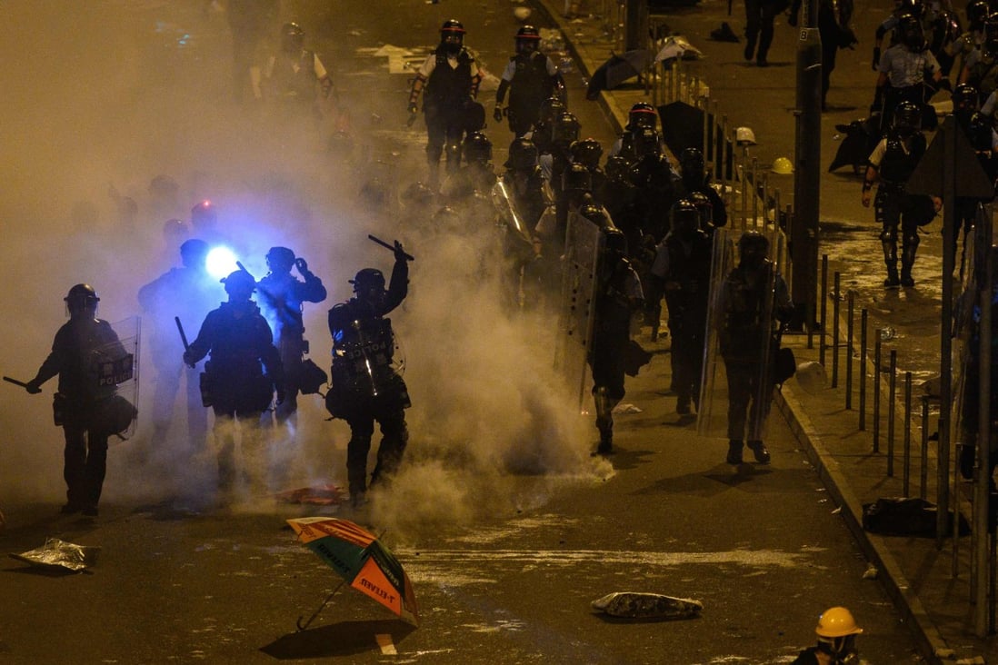 Police fire tear gas at protesters near the government headquarters in Hong Kong early on Tuesday. Photo: AFP