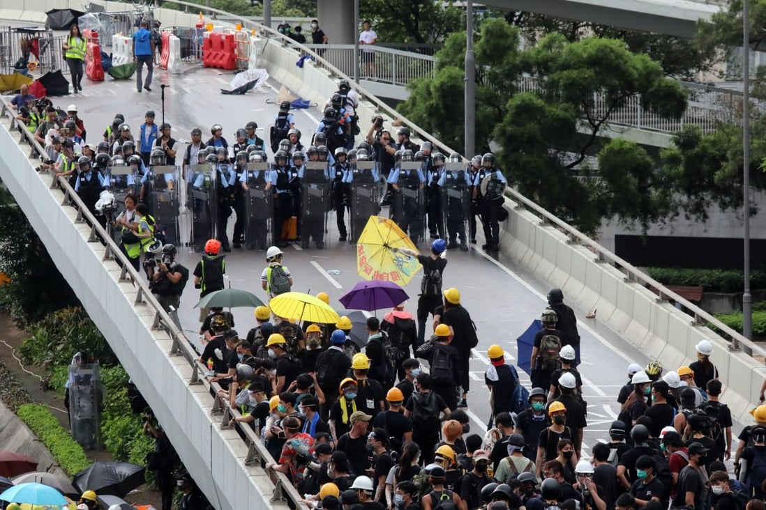 Police and protesters square off on a flyover in Admiralty on the morning of July 1. Photo: K.Y. Cheng