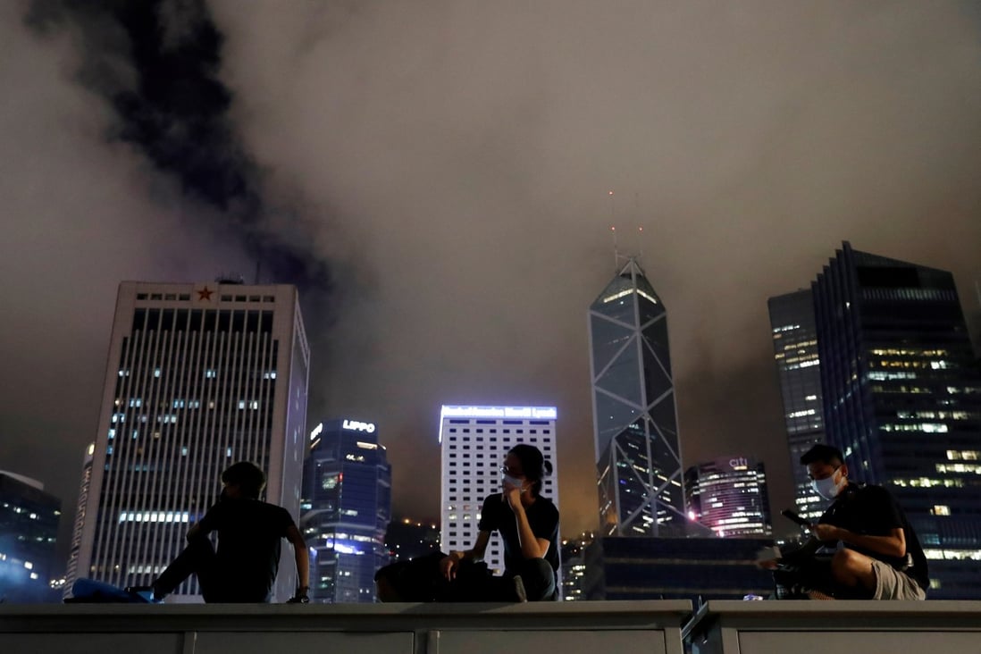 Protesters rest in front of buildings in Central district. Four deaths amid protests against the extradition bill are pointing to an alarming trend. It’s time to join hands to restore calm and hope to Hong Kong. Photo: Reuters