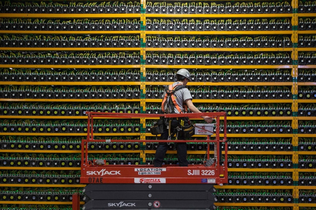 A technician inspects bitcoin mining systems at Bitfarms in Saint Hyacinthe, Quebec. File photo: AFP