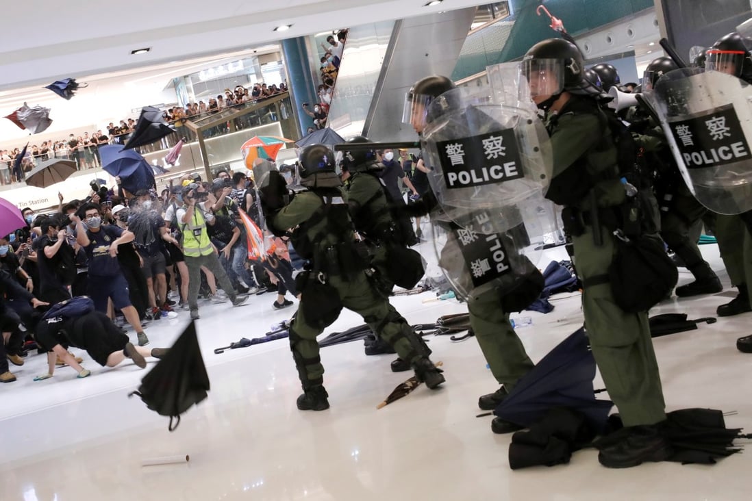 Riot police use pepper spray to disperse pro-democracy activists inside New Town Plaza mall. Photo: Reuters