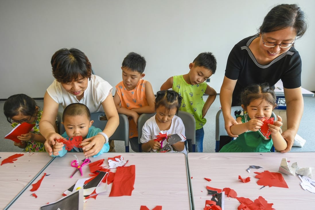 Children in Xianghe county, Hebei province, learn the traditional art of paper-cutting during their summer vacation. The over-reporting of student in enrolment in Chinese schools points to a bigger problem with obtaining an accurate population count. Photo: Xinhua