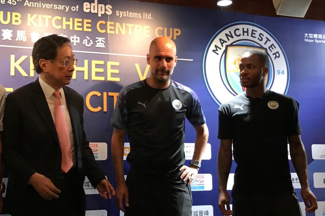 Pep Guardiola (centre) and Raheem Sterling (right) with Kitchee president Ken Ng at Tuesday’s press conference. Photo: Nicolas Atkin