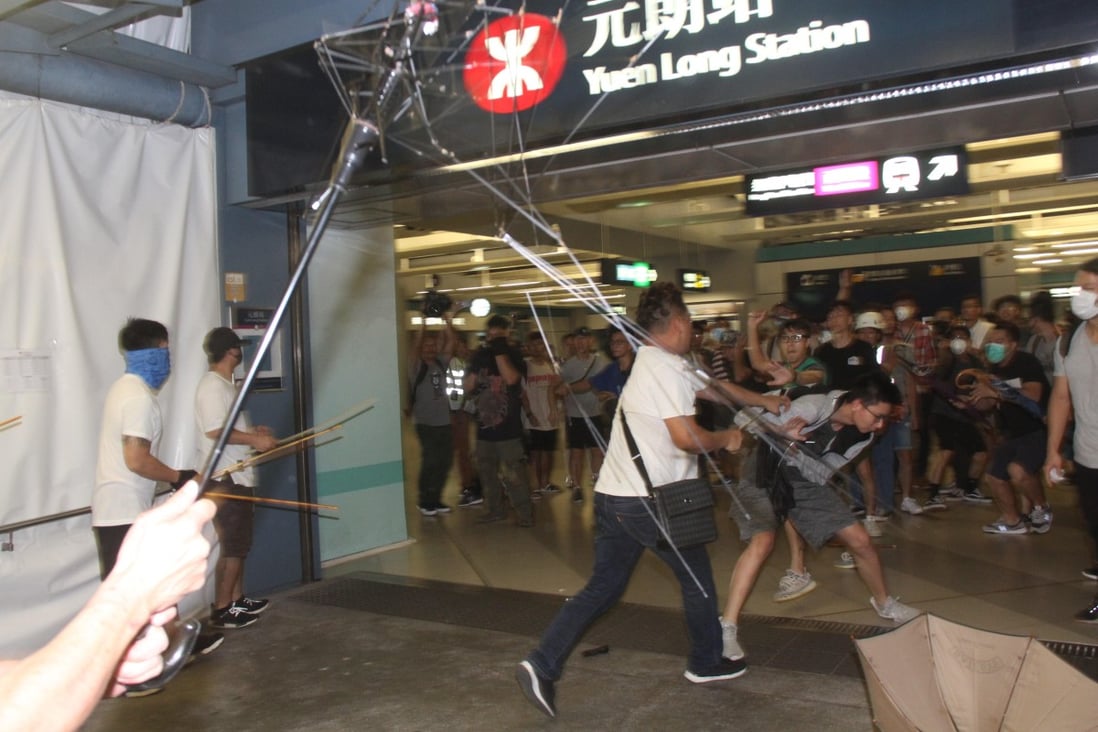 A mob of men in white T-shirts attack protesters and passengers at Yuen Long MTR station. Photo: SCMP