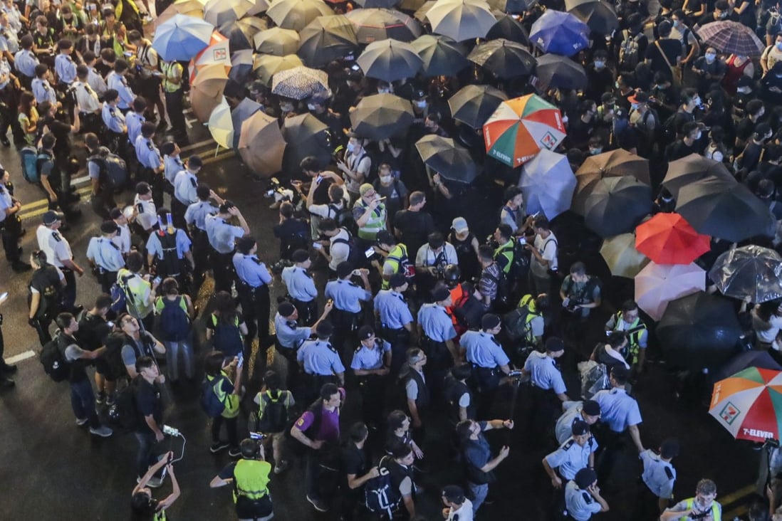 Police lines hold back protesters at an action in Tsim Sha Tsui. Photo: Edmond So