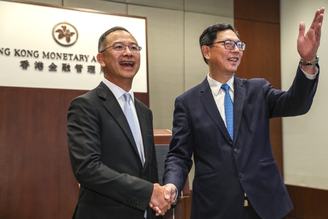 Eddie Yue Wai-man (left), succeeds Norman Chan Tak-lam (right) as the Chief Executive of Hong Kong Monetary Authority (HKMA) at HKMA office in Central on 25 July 2019. Photo: SCMP/Nora Tam