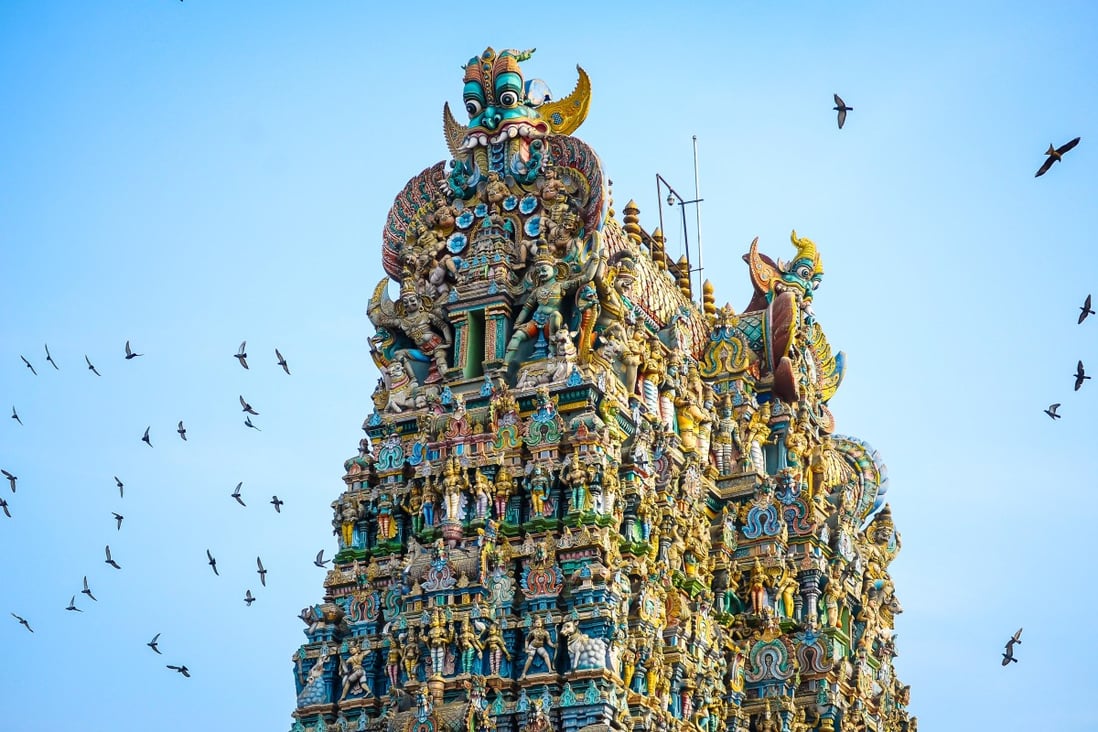 Doves fly around the Sri Meenakshi Sundareshwarar temple in Madurai, Tamil Nadu. Photo: Alamy