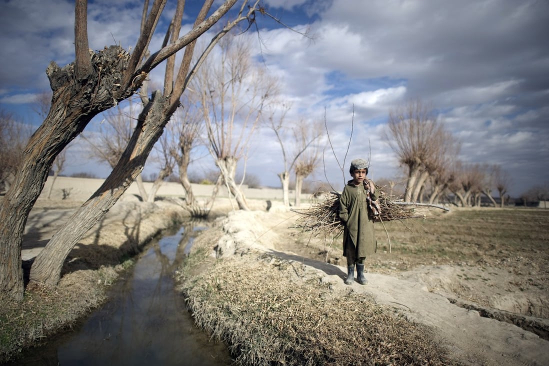 An Afghan boy outside the Musa Qala district-centre military base in Afghanistan. The Taliban insurgency has led to numerous bombings and killings since the 1990s. Photo: AFP