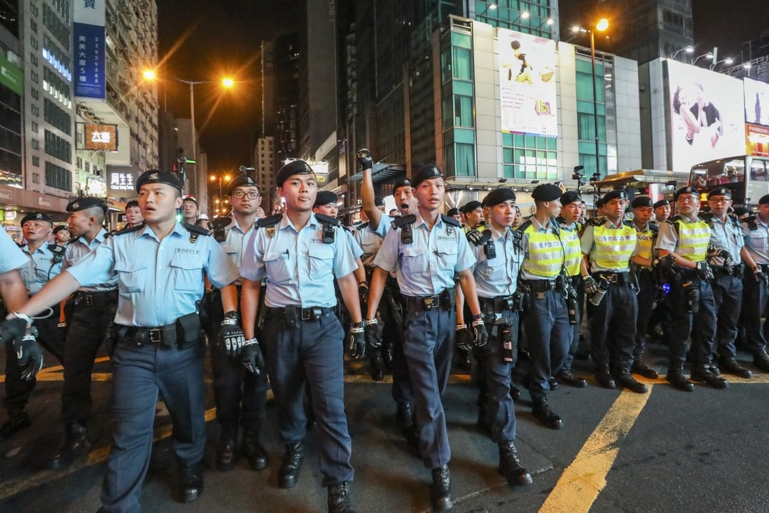 Police officers drive back protesters during unrest in Mong Kok on July 7. Photo: Dickson Lee