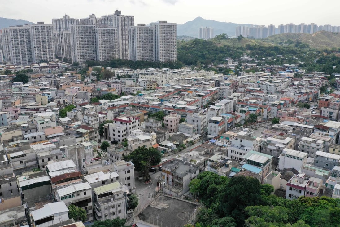 Indigenous village houses in Yuen Long, with housing estates in the background. Photo: Winson Wong