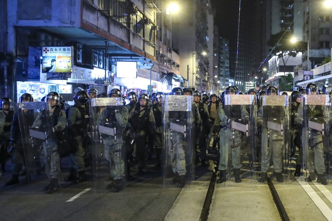Riot police prepare to push back protesters outside the central government’s liaison office in Sai Ying Pun. Photo: Sam Tsang