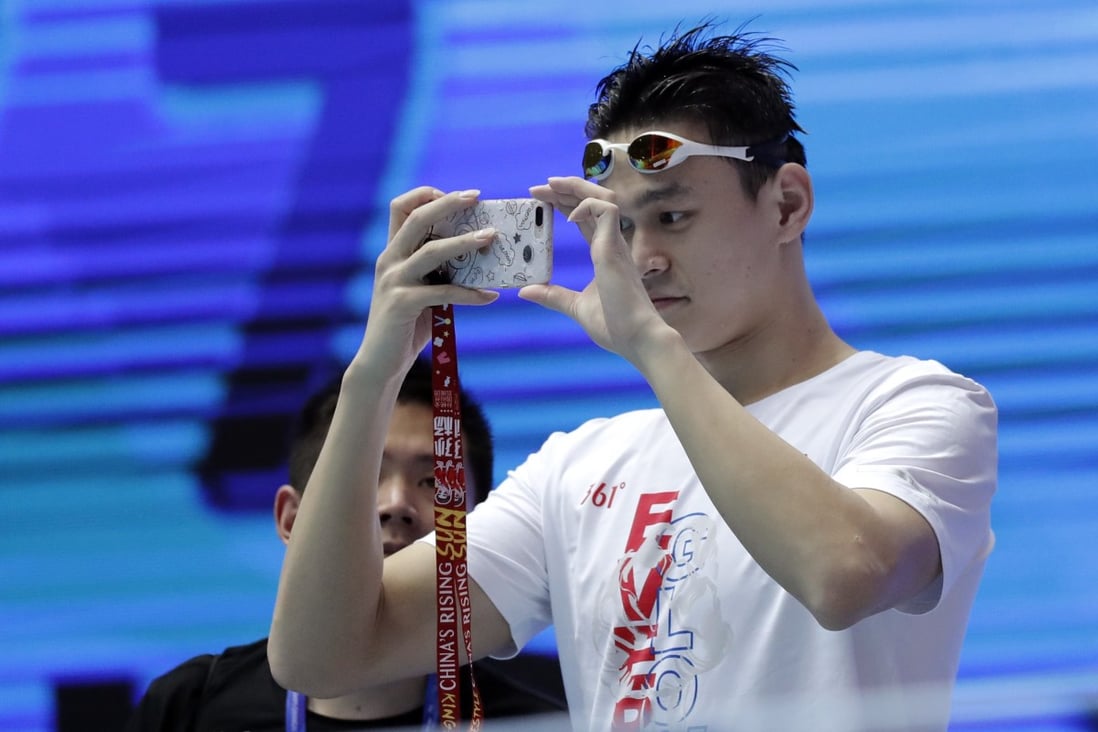 China's Sun Yang takes photos of the pool ahead of a night session at the world swimming championships. Photo: AP