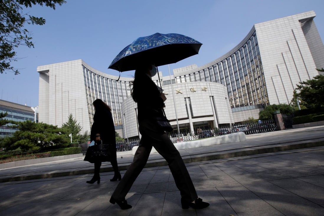 People walk past the headquarters of the People's Bank of China (PBOC), the central bank, in Beijing. Photo: Reuters