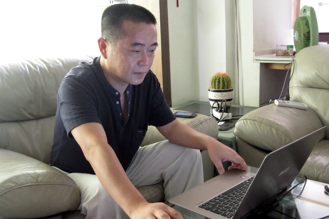 Huang Qi works on his laptop at his home in Chengdu, Sichuan province in 2012. The 56-year-old human rights activist has been jailed for a third time. Photo: AP