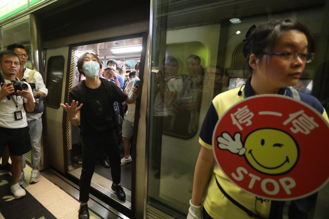Protesters started blocking the doors of a train from Tiu Keng Leng MTR station shortly before 8am. Photo: Nora Tam