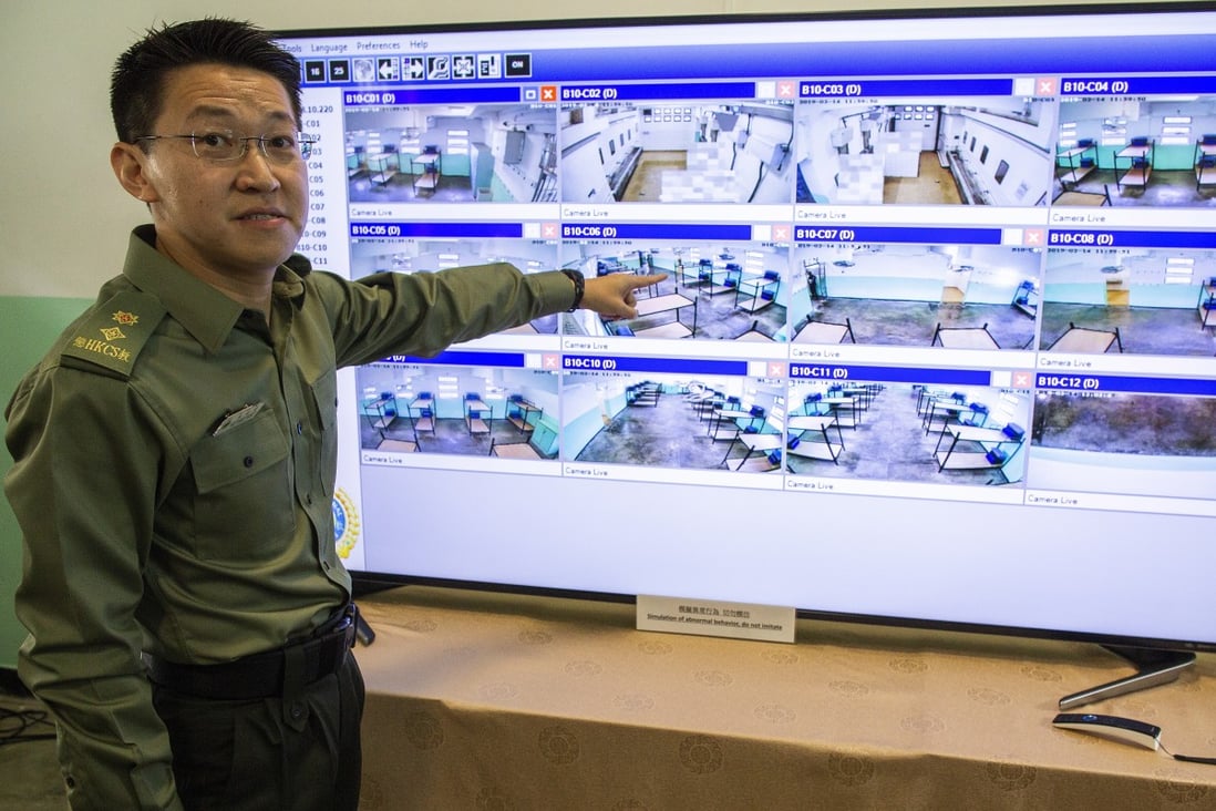 A prison guard demonstrates a high tech AI video analytics system developed by Wildfaces Technology being used at Pik Uk prison in Sai Kung, Hong Kong. Photo: EPA-EFE