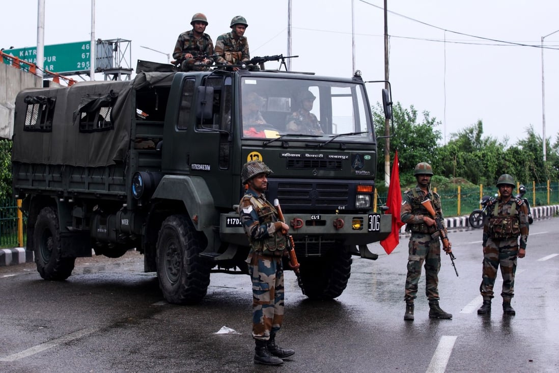 Security personnel stand guard on a street in Jammu. Photo: AFP