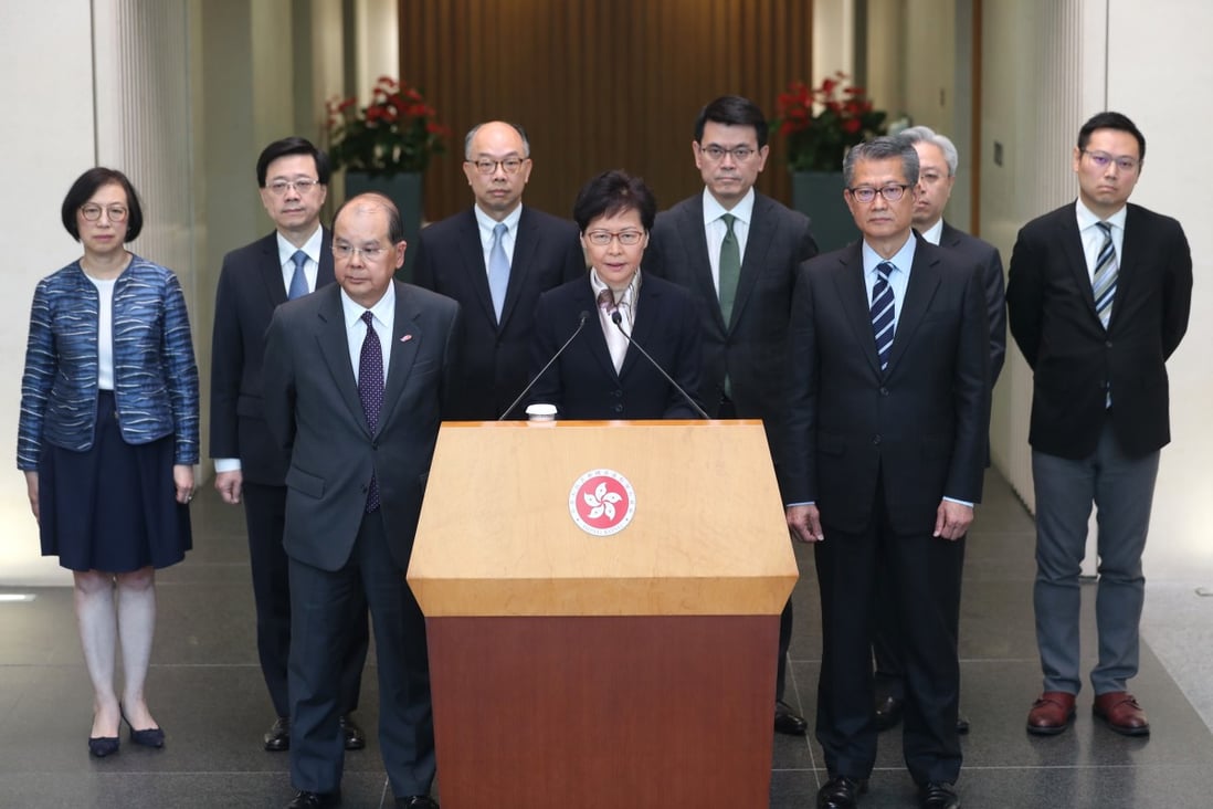 Chief Executive Carrie Lam, flanked by eight of her ministers, addresses the press in Tamar. Photo: Sam Tsang
